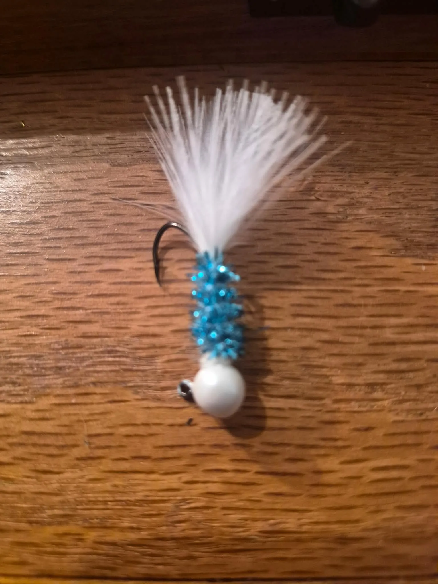Snowflake jig � orange fishing lure with pink flash